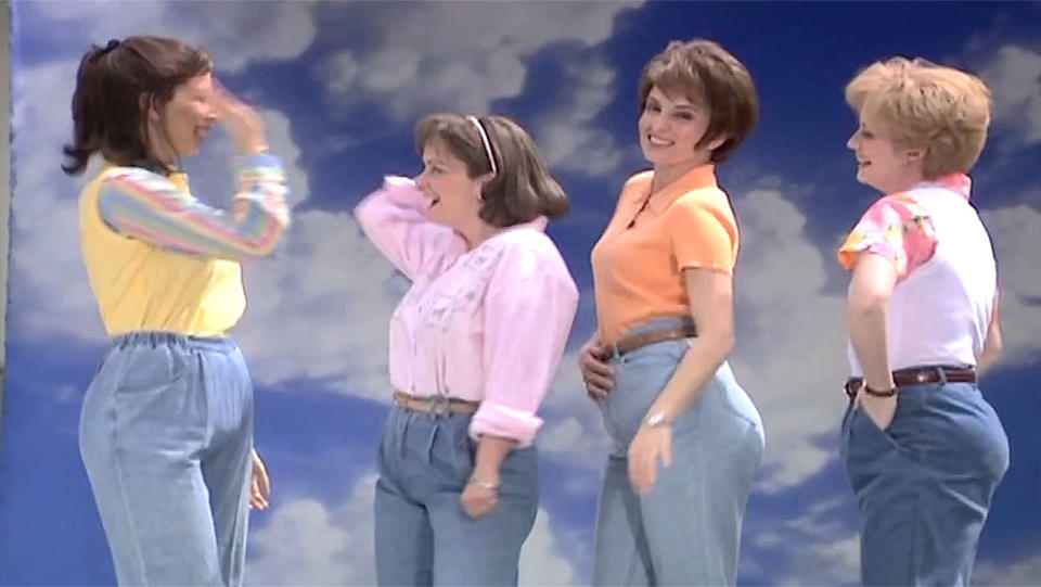 Four middle-aged women wearing "mom jeans"