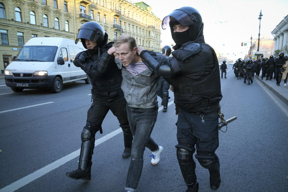 Russian policemen detain a demonstrator protesting against mobilization in St. Petersburg, Russia, Saturday, Sept. 24, 2022. Eight months after Russian President Vladimir Putin launched an invasion against Ukraine expecting a lightening victory, the war continues, affecting not just Ukraine but also exacerbating death and tension in Russia among its own citizens. (AP Photo)