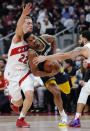 Memphis Grizzlies guard De'Anthony Melton (0) drives between Toronto Raptors guard Malachi Flynn (22) and guard Fred VanVleet during the first half of an NBA basketball game Tuesday, Nov. 30, 2021, in Toronto. (Nathan Denette/The Canadian Press via AP)