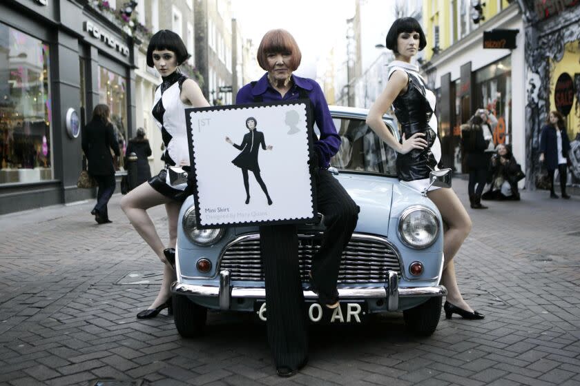 FILE - British fashion designer Mary Quant, center, poses in London on Jan. 9, 2009.