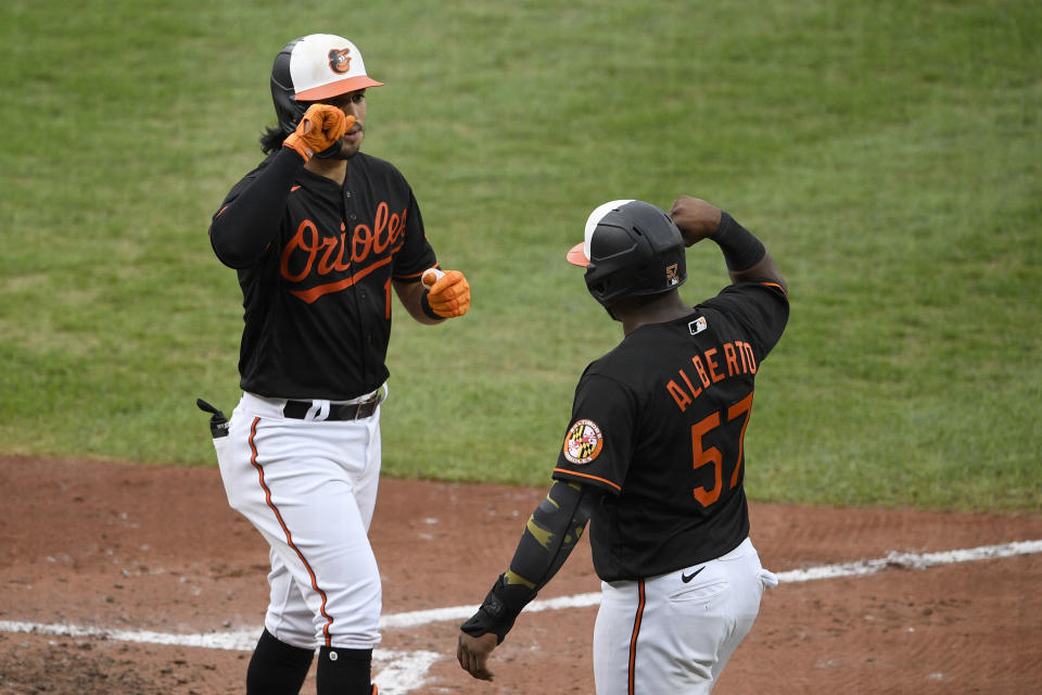 Baltimore Orioles' Rio Ruiz, left, celebrates his two-run home run with Hanser Alberto (57) during the fourth inning of the first baseball game of the team's doubleheader against the New York Yankees, Friday, Sept. 4, 2020, in Baltimore. (AP Photo/Nick Wass)