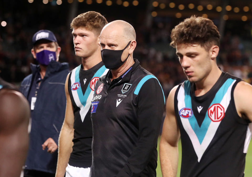 Ken Hinkley and Port Adelaide players, pictured here leaving the field after their loss to Adelaide.