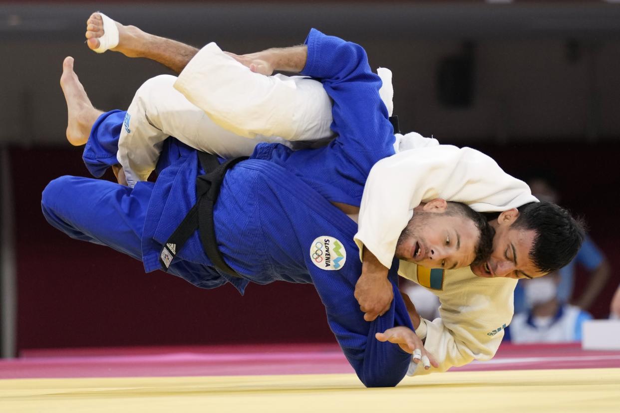 Georgii Zantaraia of Ukraine, top, and Adrian Gomboc of Slovenia compete during their men's -66kg round of 16 judo match at the 2020 Summer Olympics, Sunday, July 25, 2021, in Tokyo, Japan.