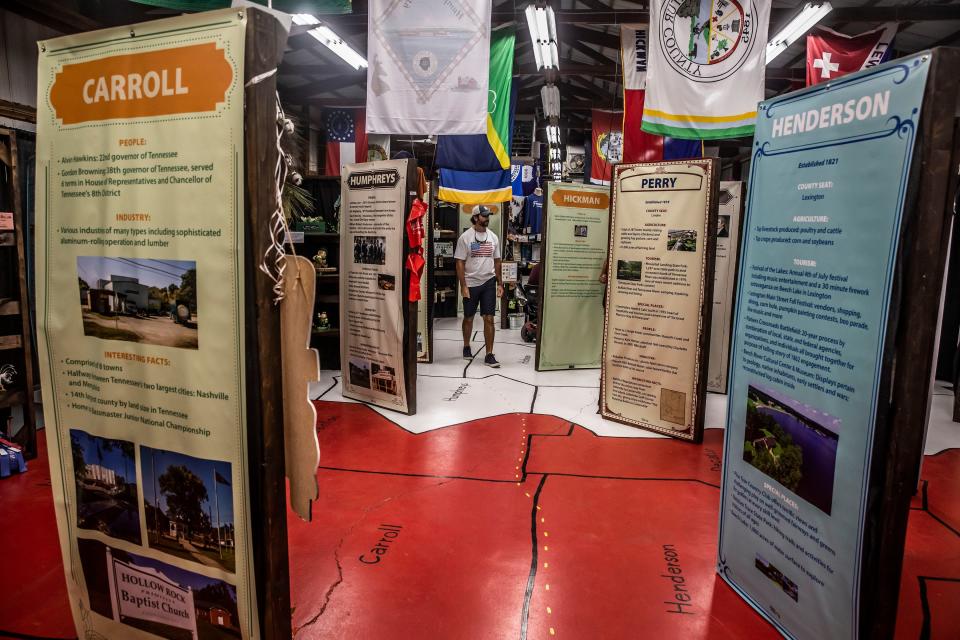 Visitors view an exhibit featuring all of Tennessee's counties at the 2022 Wilson County Fair — Tennessee State Fair  in Lebanon