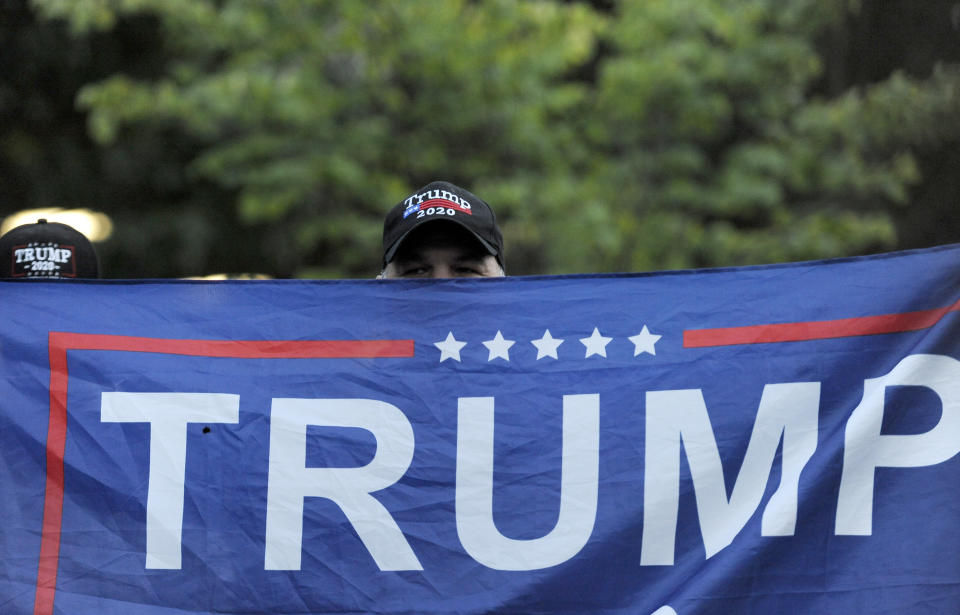 A person holds up a Trump flag at Independence Mall to support U.S. President Donald Trump as he visits the National Constitution Center to participate in the ABC News town hall, Tuesday, Sept. 15, 2020, in Philadelphia. (AP Photo/Michael Perez)