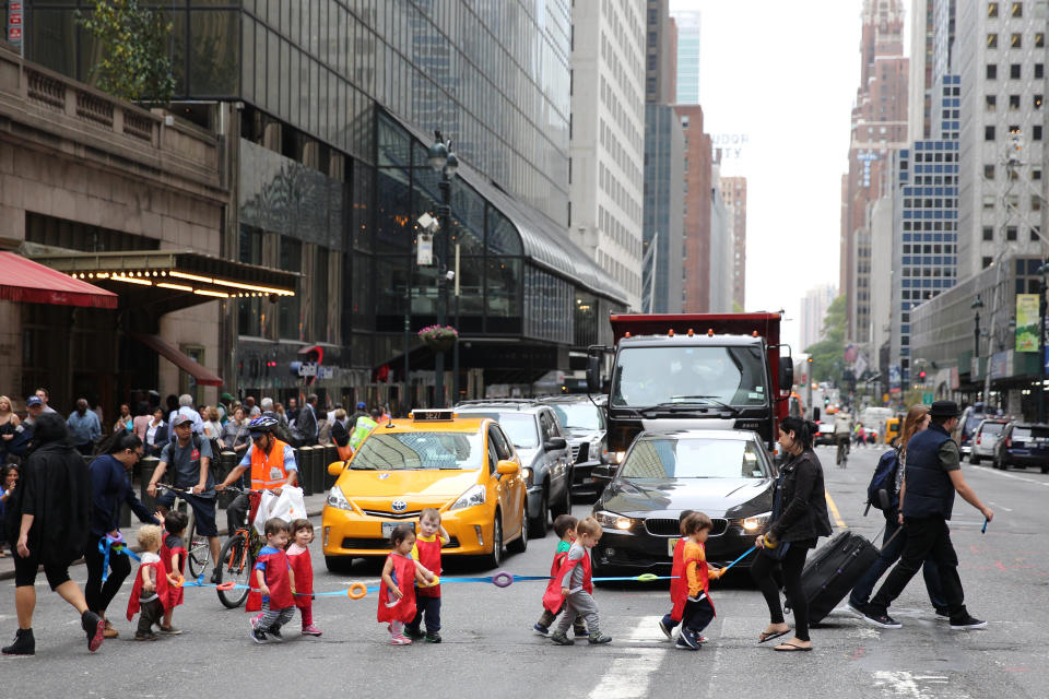 Pre schoolers cross the road with their supervisors on 42nd Street outside Grand Central Terminal in Manhattan, New York. (Credit: Tim Clayton, Getty Images)