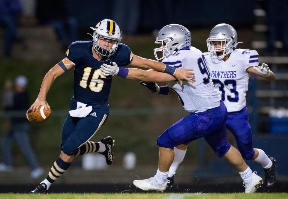 Castle's Cameron Tilly (16) runs the ball as the Castle Knights play the Bloomington South Panthers during their Class 5A Sectional 15 semifinal game in Newburgh, Ind., Friday evening, Oct. 29, 2021. 