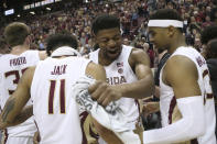 Florida State's Malik Osborne, center, celebrates with Nathanael Jack, left, and MJ Walker after clinching the ACC championship with a win over Boston College in an NCAA college basketball game Saturday, March 7 2020, in Tallahassee, Fla. Florida State won 80-62. (AP Photo/Steve Cannon)