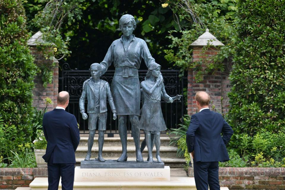 Britain's Prince William, left and Prince Harry unveil a statue they commissioned of their mother Princess Diana,  on what woud have been her 60th birthday, in the Sunken Garden at Kensington Palace, London, Thursday July 1, 2021.