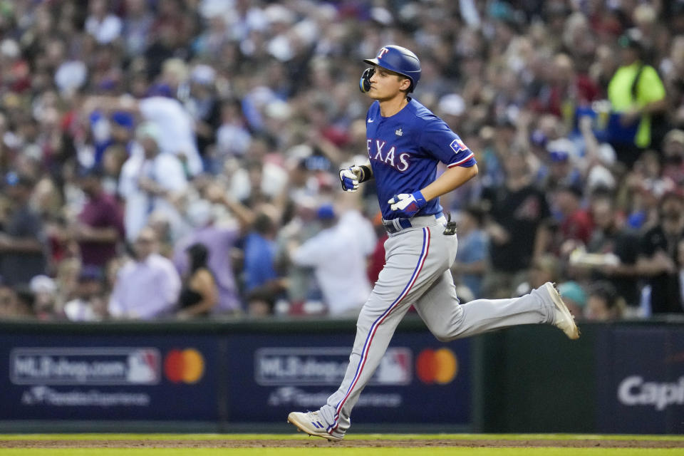 Texas Rangers' Corey Seager rounds the bases after a two-run home run against the Arizona Diamondbacks during the third inning in Game 3 of the baseball World Series Monday, Oct. 30, 2023, in Phoenix. (AP Photo/Godofredo A. Vásquez)