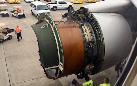 United Airlines flight 1175 sits on the tarmac in Honolulu after the mid-air drama - Credit: AP