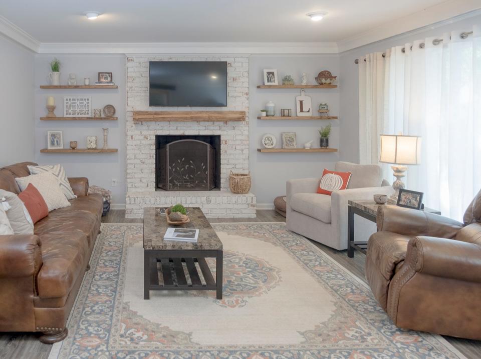 The living room has plenty of comfortable seating, as well as a working fireplace and a big screen TV.