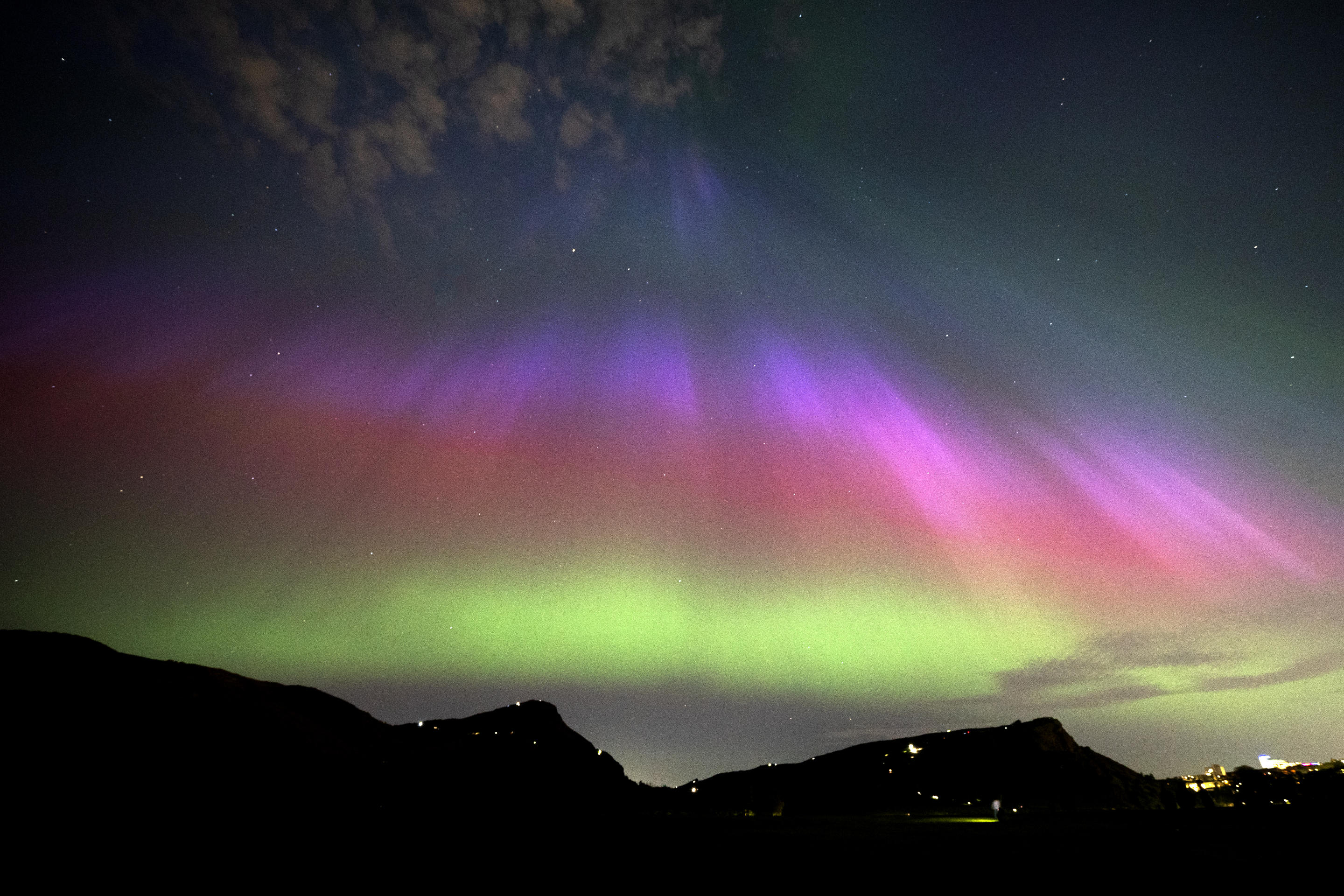 The aurora borealis, also known as the northern lights, above Arthur's Seat and Salisbury Crags in Holyrood Park, Edinburgh. Picture date: Friday May 10, 2024. (Photo by Jane Barlow/PA Images via Getty Images)