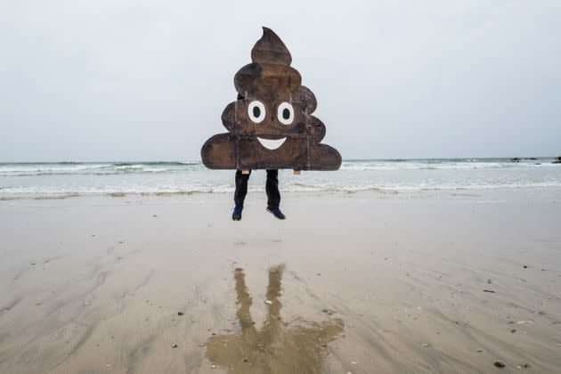 A campaigner with a placard makes a statement during the Surfers Against Sewage demonstration at Fistral Beach. (Photo: Hugh R Hastings via Getty Images)