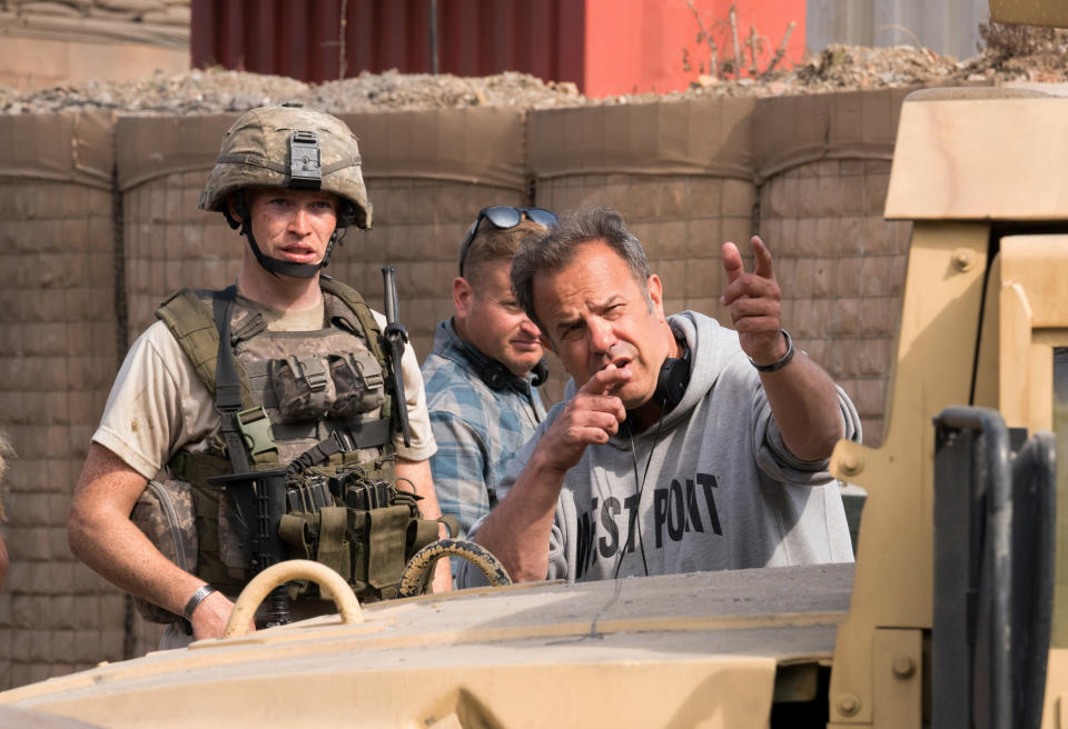 This image released by Screen Media shows Caleb Landry Jones, left, and director Rod Lurie during the filming of "The Outpost." The film tells the story of the heroic Battle of Kamdesh in Afghanistan in 2009, where the Taliban attacked a remote American Combat Outpost that was nearly impossible to defend. (Screen Media via AP)