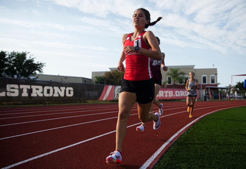 ECS’s Ava Povich leads the 1600 m run over FBA’s Katie Beam during the Private 8 meet at ECS on Friday, April 8, 2022. Povich won.