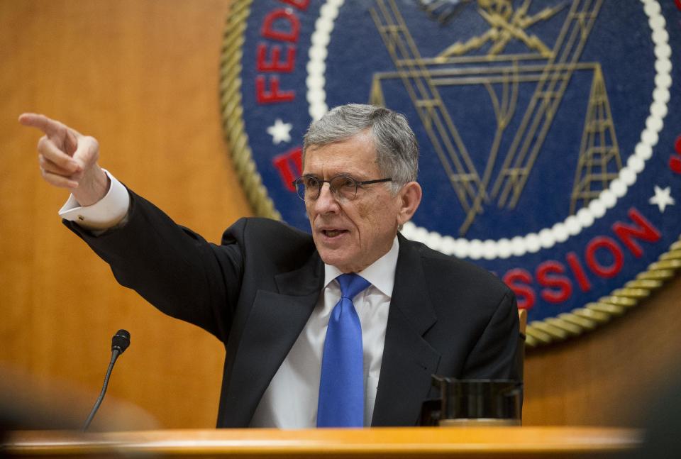 Federal Communications Commission (FCC) Chairman Tom Wheeler gestures as he speaks during an open hearing in Washington, Thursday, Feb. 26, 2015. The FCC votes on a plan that would require Internet providers like Comcast, Verizon AT&T and others to act in the public interest when providing a mobile connection to your home or phone. The industry is widely expected to go to court to find the regulation, once approved. (AP Photo/Pablo Martinez Monsivais)