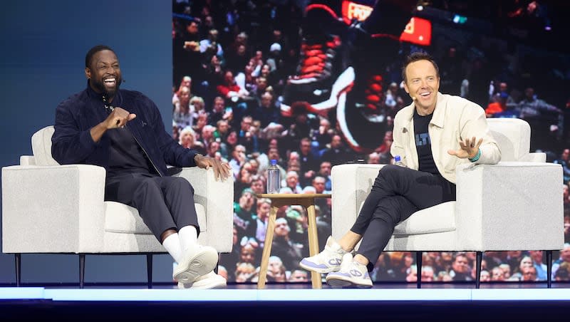 Dwyane Wade, former NBA player and Utah Jazz minority owner, and Ryan Smith, Qualtrics co-founder and Utah Jazz majority owner, talk at the Qualtrics X4 Tech Summit at the Salt Palace Convention Center in Salt Lake City on Thursday.