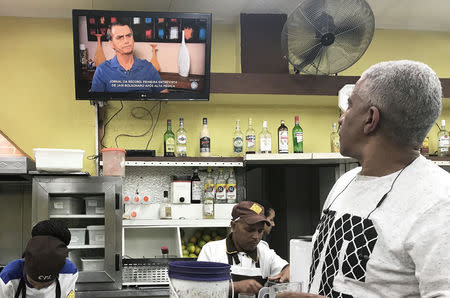 A man watches an interview on television with presidential candidate Jair Bolsonaro at a bar in Sao Paulo, Brazil, October 4, 2018. REUTERS/Nacho Doce