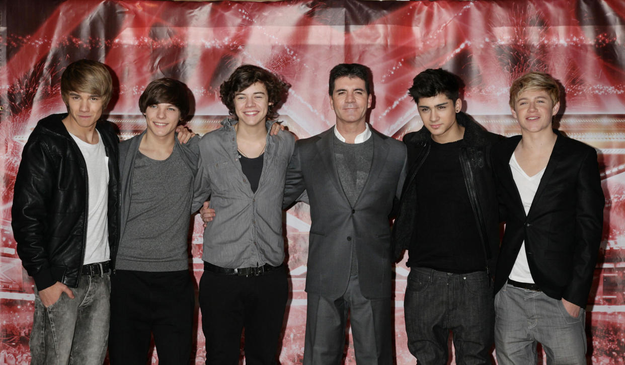 Simon Cowell with One Direction (from left) Liam Payne, Louis Tomlinson, Harry Styles, Zayn Malik and Niall Horan attending a press conference for X Factor, at The Connaught Hotel in central London.   (Photo by Yui Mok/PA Images via Getty Images)