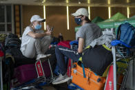 Students from Norway who were on a field trip to South Africa wait to be tested for COVID-19 before boarding a flight to Amsterdam at Johannesburg's OR Tambo's airport Monday Nov. 29, 2021. The World Health Organisation urged countries around the world not to impose flight bans on southern African nations due to concern over the new omicron variant. (AP Photo/Jerome Delay)