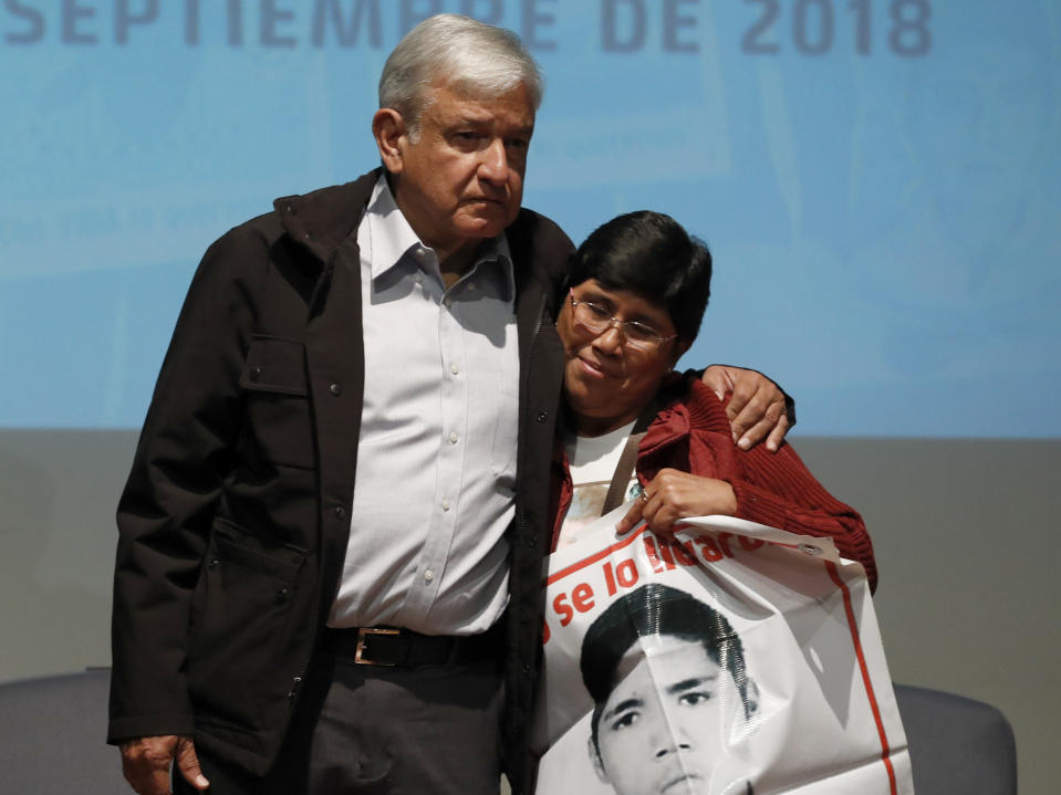 ADDS NAME OF WOMAN - President-elect Andres Manuel Lopez Obrador Maria Elena Guerrero, mother of one of the 43 college students who disappeared on Sept. 26, 2014, at the Memory and Tolerance Museum in Mexico City, Wednesday, Sept. 26, 2018. Later in the day, family members and supporters, who do not accept the findings of government investigations, will march to mark four years since the students disappearance at the hands of police. (AP Photo/Rebecca Blackwell)