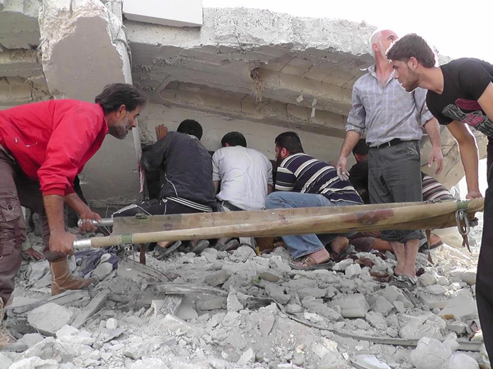 In this Wednesday, Oct. 17, 2012 photo. citizen journalism image provided by Edlib News Network, ENN, which has been authenticated based on its contents and other AP reporting, Syrian citizens search under rubble to rescue people from a building that was destroyed from a Syrian forces airstrike, at Kfar Nebel town, in Idlib province, northern Syria. (AP Photo/Idlib News Network ENN)