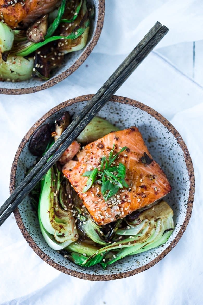 Teriyaki salmon with bok choy in a bowl.