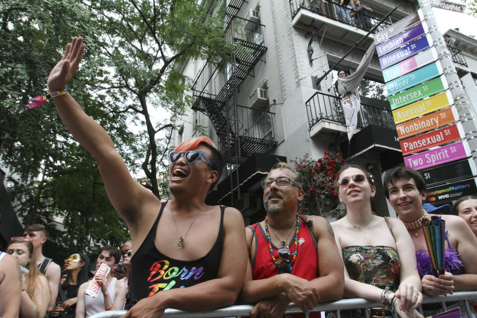 Spectators react as the LBGTQ Pride march makes its way along Christopher Street in New York, Sunday, June 30, 2019. (AP Photo/Tina Fineberg)