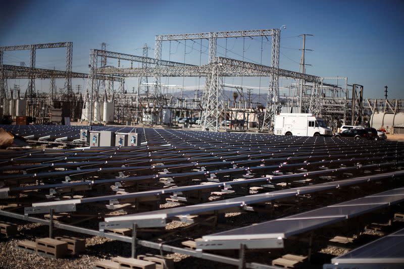 FILE PHOTO: Solar panels are seen next to a Southern California Edison electricity station in Carson