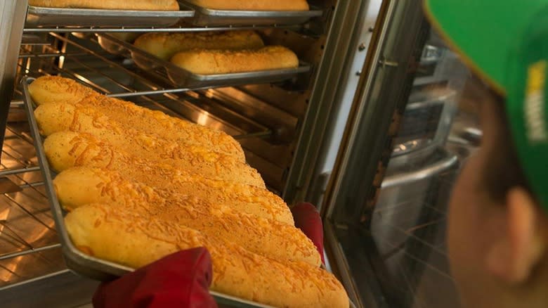 Subway employee baking bread