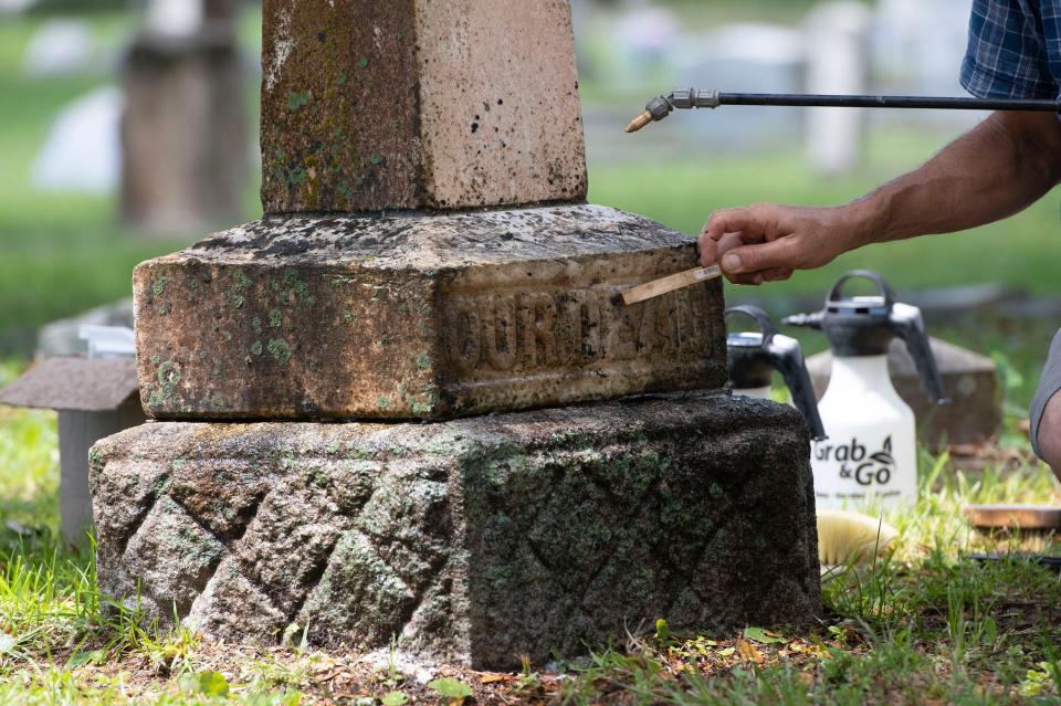 John Appell, owner of Atlas Preservation in Southington, Connecticut, teaches a group of volunteers nondestructive cleaning and restoration techniques for cleaning gravestones at the historic St. Michael's Cemetery on Thursday.