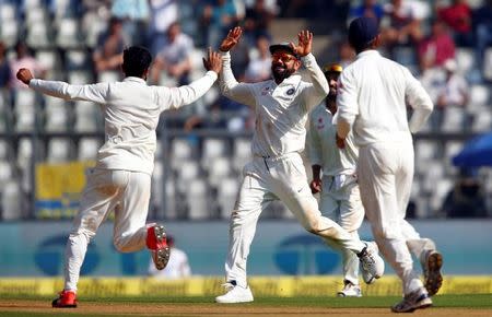 India's Virat Kohli (C) celebrates with teammates the wicket of England's Adil Rashid during the Mumbai cricket test at Wankhede Stadium, December 9, 2016. REUTERS/Danish Siddiqui