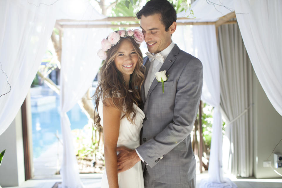 a wedding couple smiling