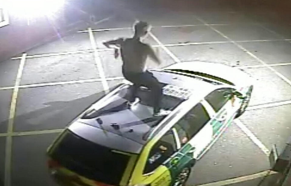 Police have released CCTV to appeal for the identity a man who jumped up and down on a rapid response ambulance. (SWNS)