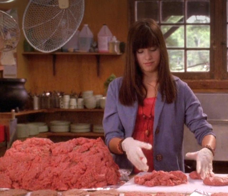 A person with a huge pile of ground meat in the kitchen