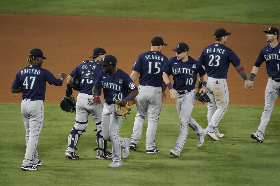 Seattle Mariners celebrate a 6-2 win against the Los Angeles Angels in a baseball game in Anaheim, Calif., Thursday, June 3, 2021. (AP Photo/Jae C. Hong)