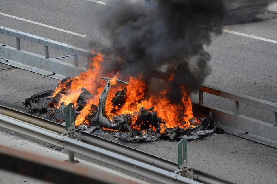 An electric-powered Tesla car burns after a crash on the Swiss A2 motorway on Monte Ceneri near Bellinzona, Switzerland May 10, 2018 (REUTERS)