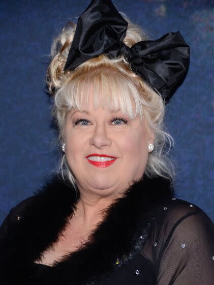 Victoria Jackson in a black dress with a black bow in her hair