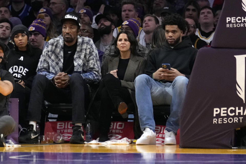 Former NBA players Miles Bridges, right, and Scottie Pippen, second from left, watch the second half of a basketball game between the Los Angeles Lakers and the Charlotte Hornets on Friday, Dec. 23, 2022, in Los Angeles. (AP Photo/Marcio Jose Sanchez)