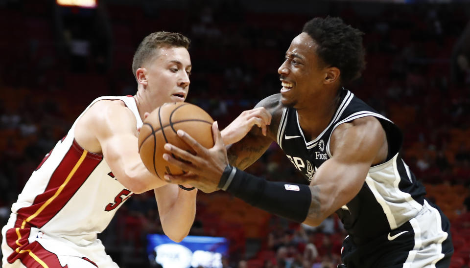 San Antonio Spurs guard DeMar DeRozan (10) attempts to shoot the ball against Miami Heat forward Duncan Robinson (55) during the first half of an NBA preseason basketball game Tuesday, Oct. 8, 2019, in Miami. (AP Photo/Brynn Anderson)