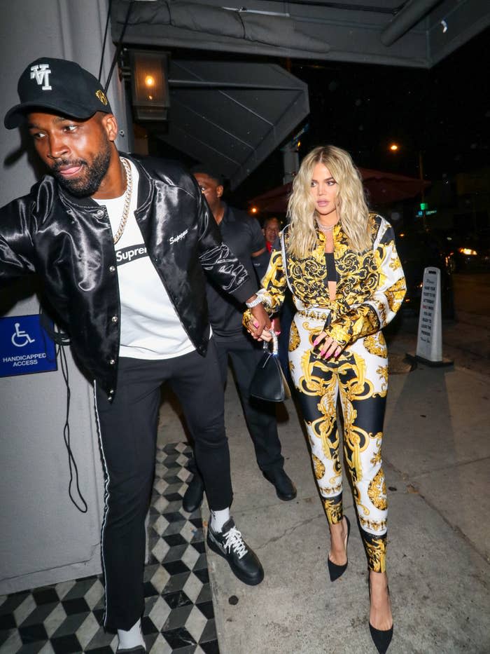 tristan leading khloe into a building