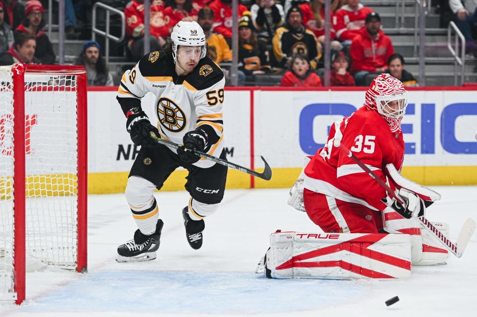 Boston Bruins left wing Tyler Bertuzzi attempts to score as Detroit Red Wings goaltender Ville Husso defends the net during the first period at Little Caesars Arena, March 12, 2023.