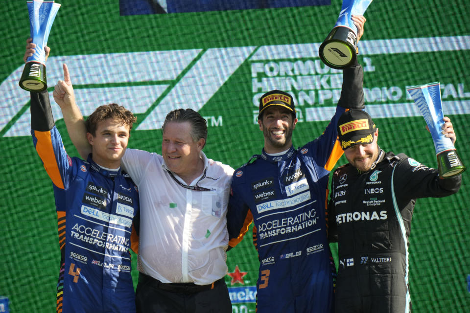 From left: Mclaren driver Lando Norris of Britain, Mclaren CEO Zak Brown, Mclaren driver Daniel Ricciardo of Australia and Mercedes driver Valtteri Bottas of Finland celebrate on the podium after the Italian Formula One Grand Prix, at Monza racetrack, in Monza, Italy, Sunday, Sept.12, 2021. (AP Photo/Luca Bruno)