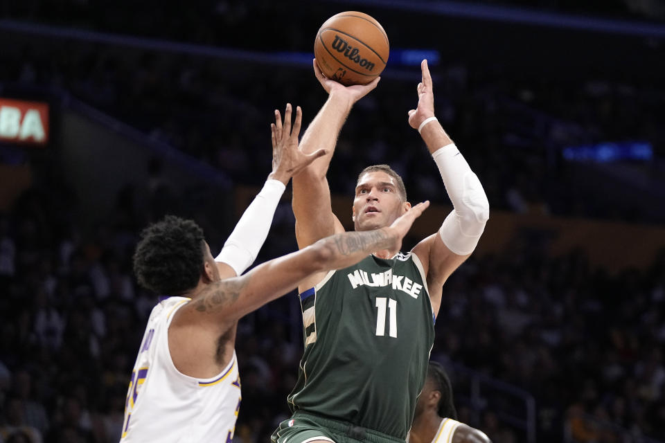 Milwaukee Bucks center Brook Lopez, right, shoots as Los Angeles Lakers forward Christian Wood defends during the first half of an NBA preseason basketball game Sunday, Oct. 15, 2023, in Los Angeles. (AP Photo/Mark J. Terrill)