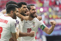 Iran's team players celebrate at the end of the World Cup group B soccer match between Wales and Iran, at the Ahmad Bin Ali Stadium in Al Rayyan , Qatar, Friday, Nov. 25, 2022. (AP Photo/Pavel Golovkin)