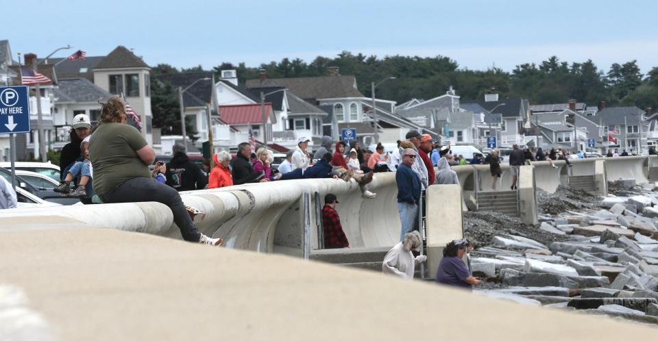 People gather at North Beach in Hampton ahead of high tide Saturday, Sept. 16, 2023, hoping to see high waves brought on by the effects of Hurricane Lee.