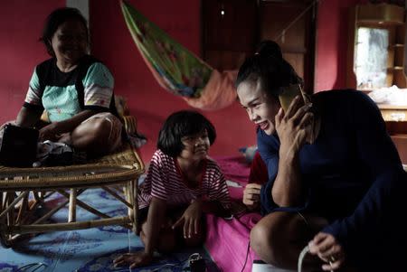 Muay Thai boxer Nong Rose Baan Charoensuk, 21, who is transgender, spends time with her family at her house in Phimai district in Nakhon Ratchasima province, Thailand, July 18, 2017. REUTERS/Athit Perawongmetha