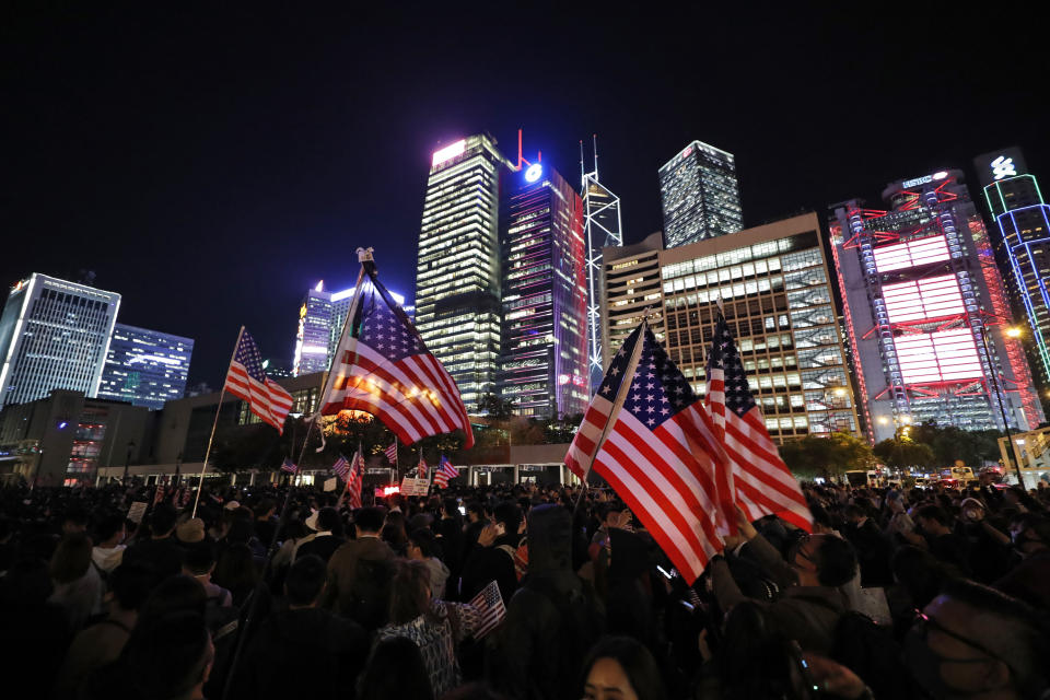 Protester holds U.S. flags during a demonstration in Hong Kong, Thursday, Nov. 28, 2019. China’s fury over President Donald Trump’s decision to sign legislation supporting human rights in Hong Kong is evident. What’s less clear what “countermeasures” Beijing may take in response to what it said Thursday were “extremely evil” and dangerous moves. (AP Photo/Vincent Thian)