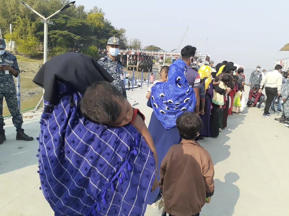 Rohingya refugees board a ship as they are ferried to Bhasan Char, or floating island, in the Bay of Bengal, from Cox’s Bazar, Bangladesh. (AP Photo/Saleh Noman)